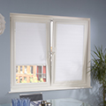 White perfect fit blinds in a dining room setting.