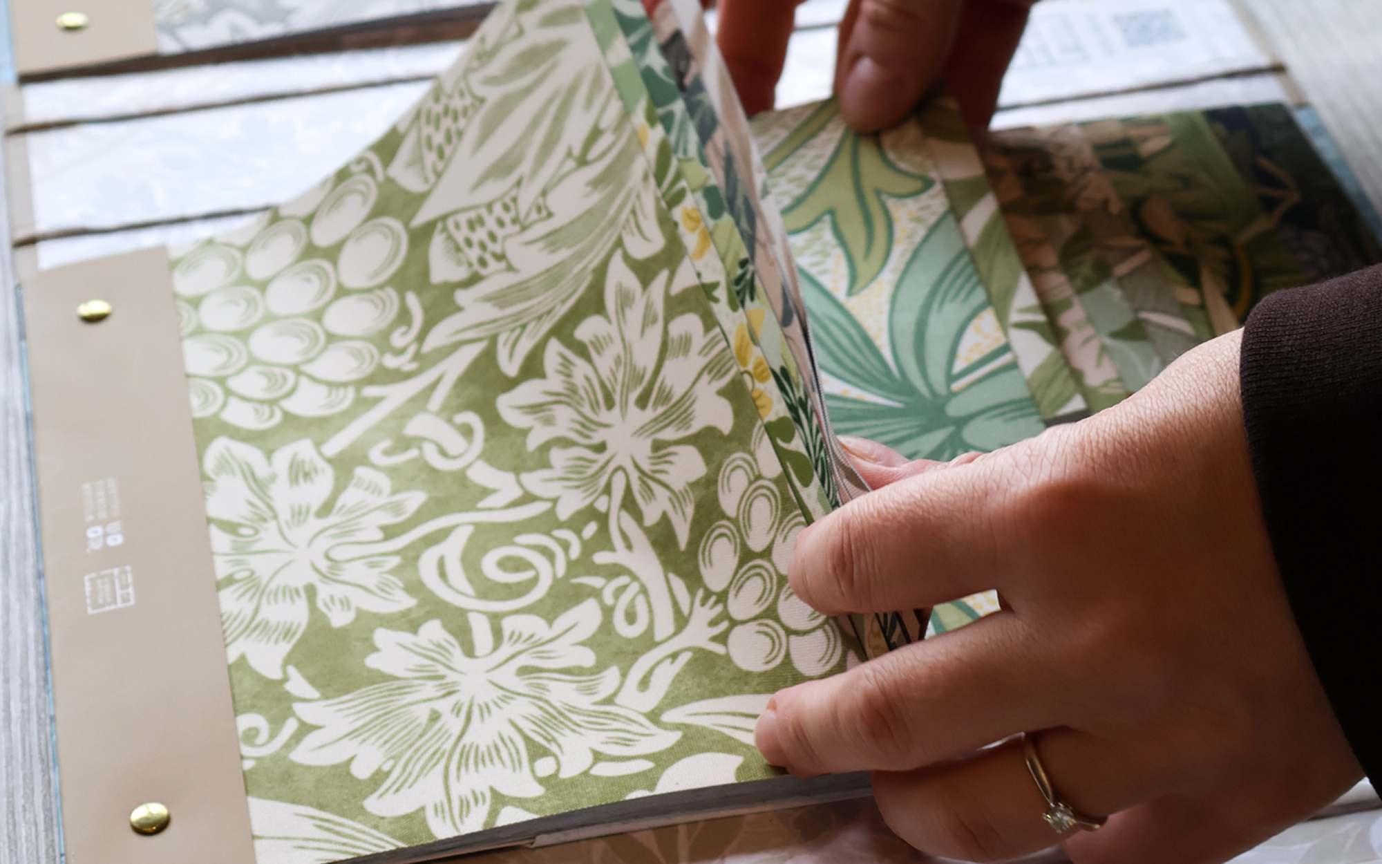 William Morris Roller Blind Collection pattern book displayed alongside fabric samples featuring classic William Morris designs.