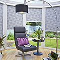 Intu blinds with a bonsai tree pattern in a conservatory setting.