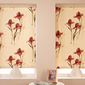Laminated blind with a floral motif pattern.