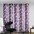 Purple floral design panel blinds with chair and foot stool in the foreground.