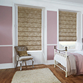 Patterned roman blinds in a bedroom setting.