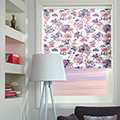 Floral patterned roman blinds in a living room setting.
