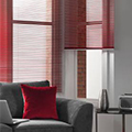 Red berry coloured venetian blind in a living room setting.