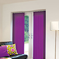 Purple coloured vertical blinds in a living room setting.