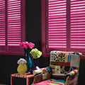 Pink coloured window shutters.
