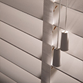 Detail of white wood slat blind.